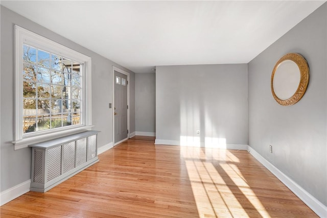 entrance foyer with radiator and light hardwood / wood-style floors