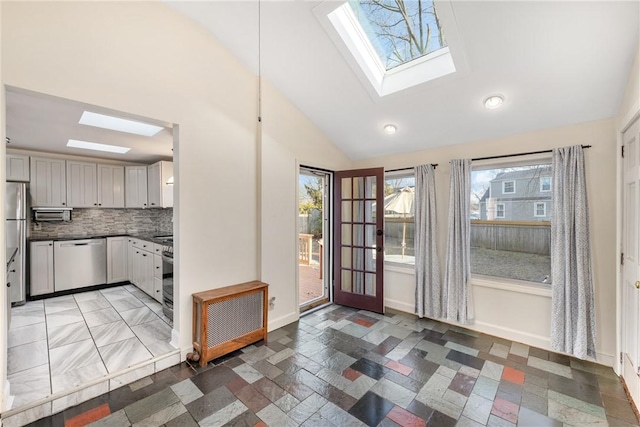 interior space with a skylight and high vaulted ceiling