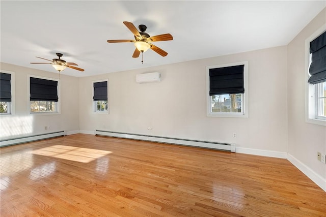 empty room with a baseboard heating unit, ceiling fan, a wall mounted AC, and light wood-type flooring