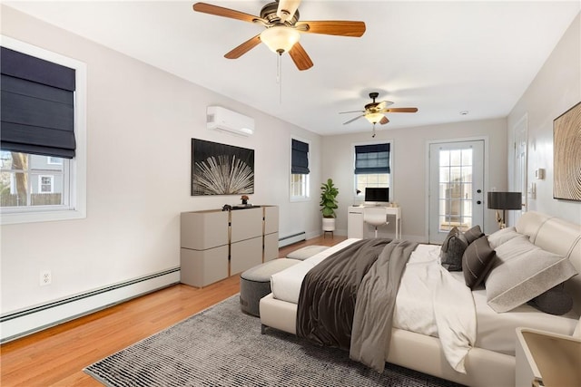 bedroom with a wall mounted air conditioner, hardwood / wood-style flooring, ceiling fan, and baseboard heating