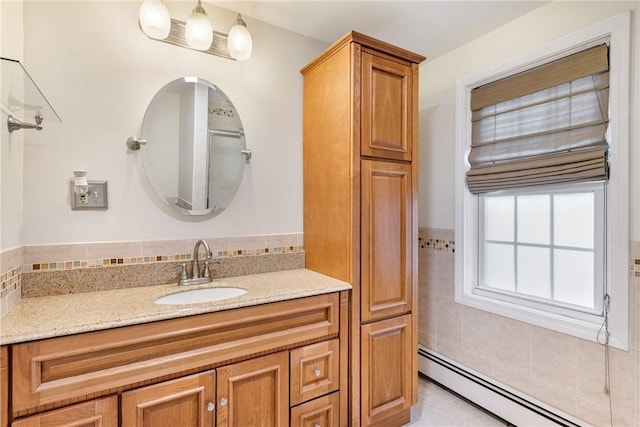 bathroom with vanity and a baseboard heating unit