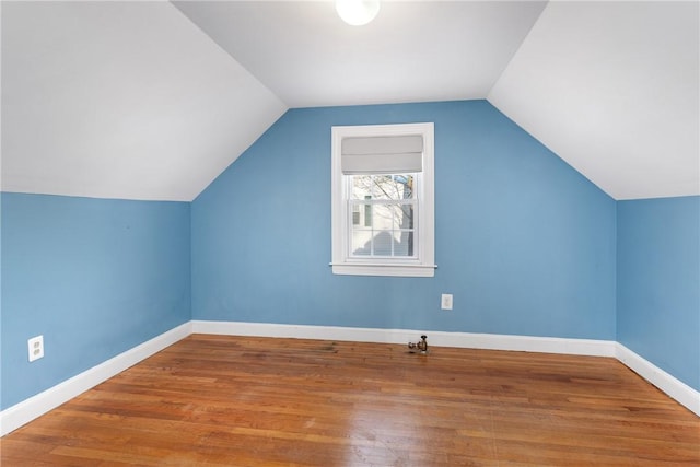 bonus room featuring hardwood / wood-style flooring and lofted ceiling