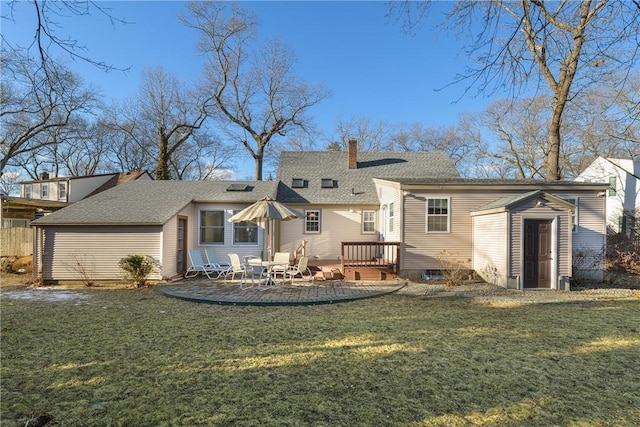 back of house with a patio and a lawn