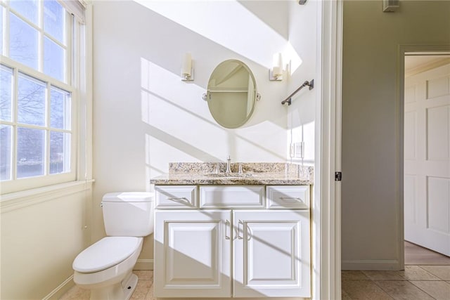 bathroom with vanity, tile patterned flooring, and toilet