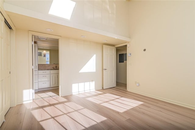 empty room featuring sink and light hardwood / wood-style flooring