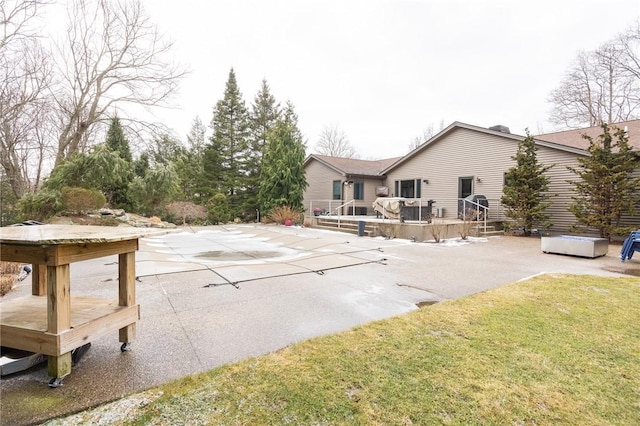 exterior space featuring a wooden deck, a yard, and a patio area