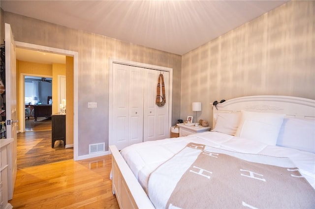 bedroom featuring a closet and light hardwood / wood-style flooring