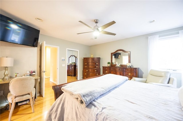 bedroom featuring ceiling fan, a closet, and light hardwood / wood-style flooring