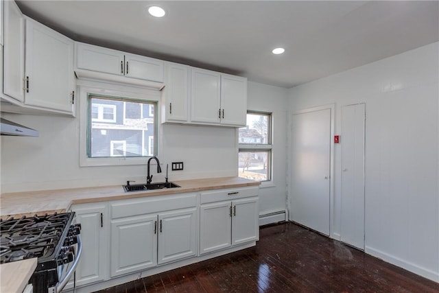 kitchen featuring sink, white cabinets, and gas range oven