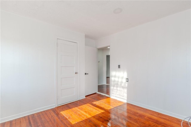 spare room with hardwood / wood-style floors