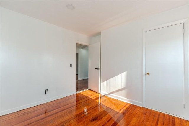 unfurnished bedroom with hardwood / wood-style flooring