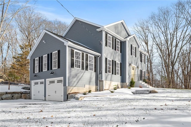 view of snow covered exterior with an attached garage