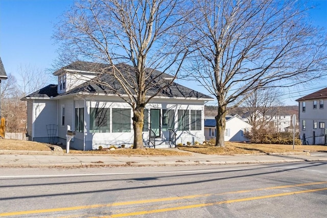 view of front facade with a sunroom