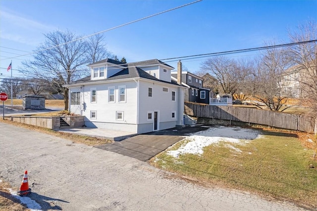 view of side of home with a yard