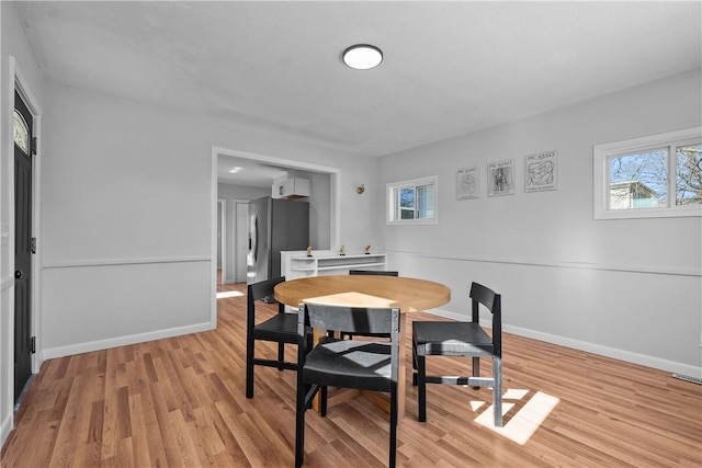 dining space with light hardwood / wood-style flooring