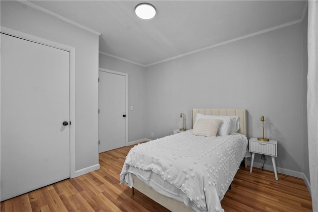 bedroom featuring wood-type flooring and ornamental molding