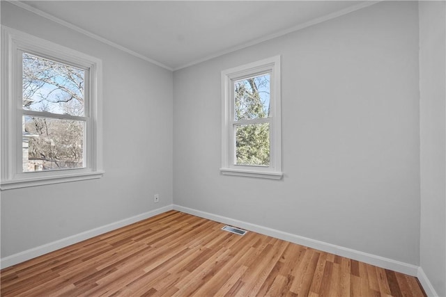 unfurnished room featuring crown molding and light hardwood / wood-style flooring