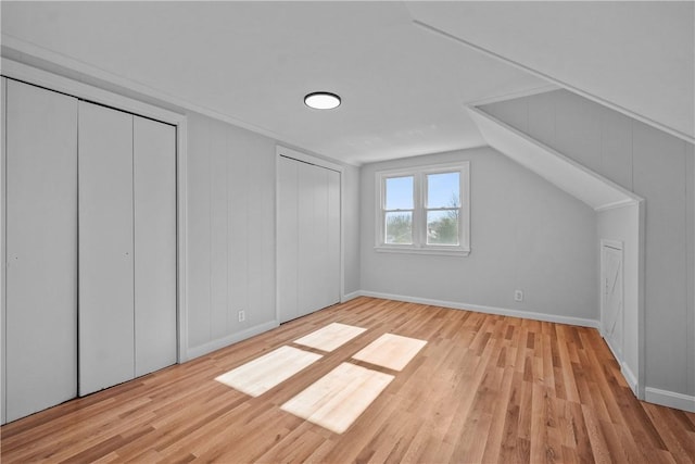 bonus room featuring lofted ceiling and light hardwood / wood-style flooring