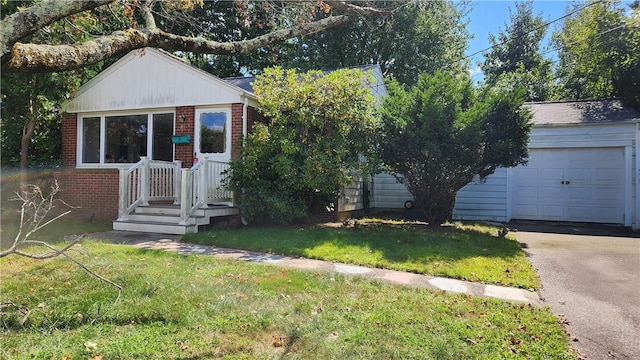 view of front of home featuring a garage, brick siding, driveway, and a front lawn