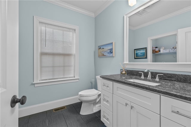 bathroom with crown molding, vanity, and toilet