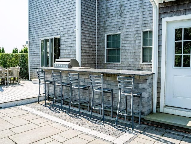 view of patio / terrace featuring area for grilling and a bar