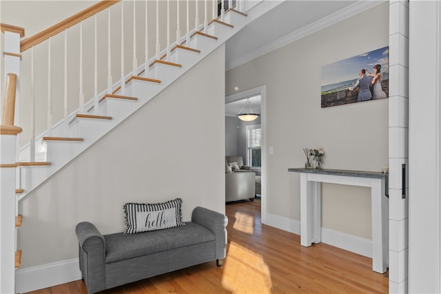 interior space featuring wood-type flooring and ornamental molding