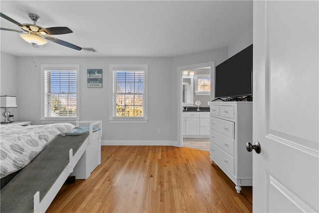 bedroom featuring connected bathroom, ceiling fan, and light hardwood / wood-style flooring