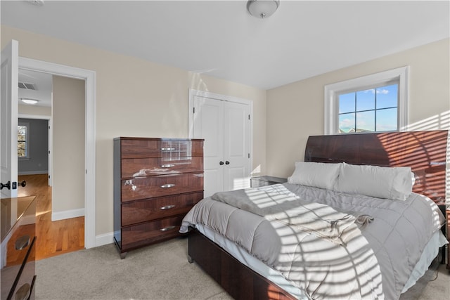 carpeted bedroom featuring a closet