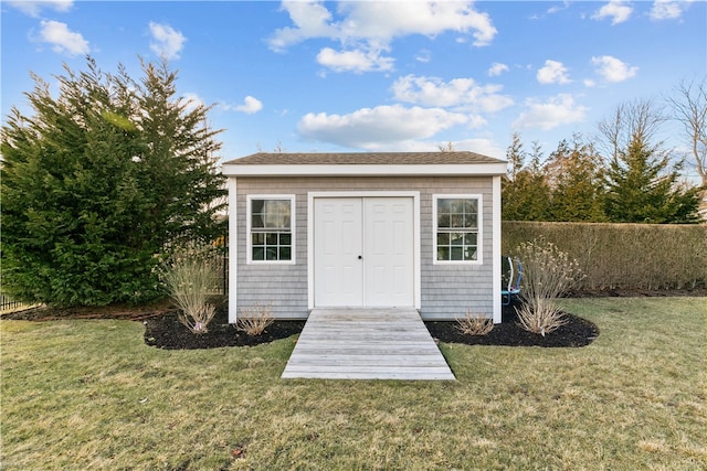 view of outbuilding featuring a yard