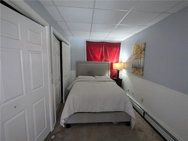 bedroom featuring a baseboard radiator and a paneled ceiling