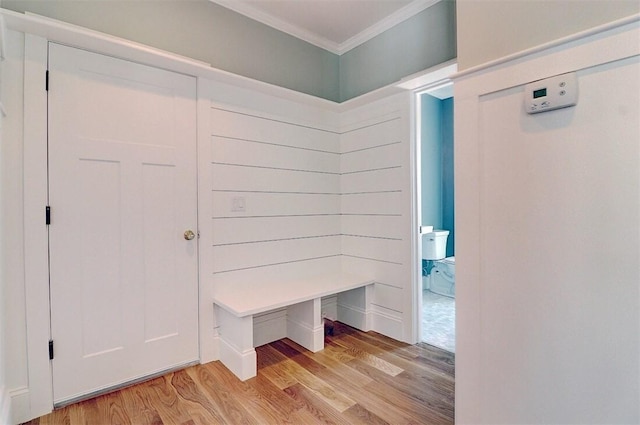 mudroom with light hardwood / wood-style flooring and ornamental molding