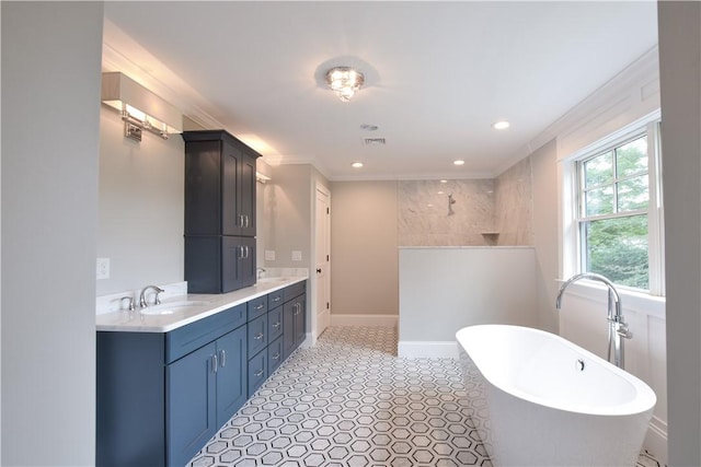 bathroom featuring vanity, crown molding, and a tub