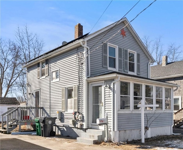 rear view of property with a sunroom