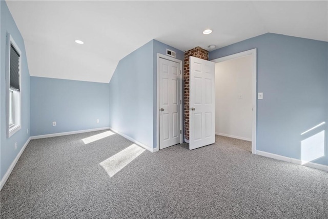 additional living space with lofted ceiling and carpet floors