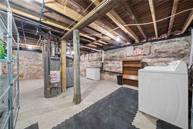 basement featuring gas water heater and washer and clothes dryer