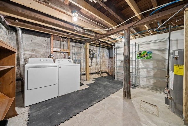 basement with washer and clothes dryer, gas water heater, and electric panel