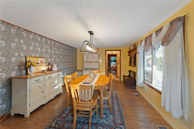 dining area featuring hardwood / wood-style floors and a textured ceiling