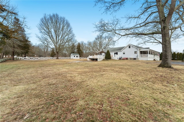 view of yard featuring a storage shed and a sunroom