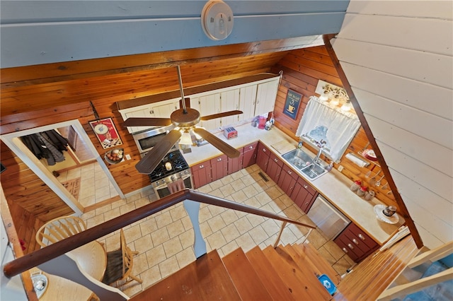 unfurnished living room with sink and wood walls