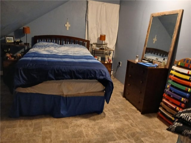 bedroom with lofted ceiling