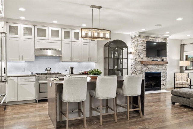 3 White Hawk Rdg, Richmond, RI 02898 - kitchen with pendant lighting, white cabinetry, a breakfast bar area, a center island, and high end stainless steel range