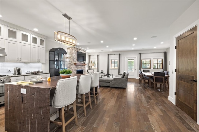 3 White Hawk Rdg, Richmond, RI 02898 - kitchen featuring a kitchen island, dark hardwood / wood-style floors, stainless steel gas stove, decorative light fixtures, and white cabinetry