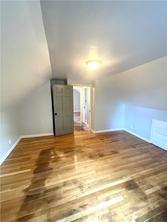 bonus room featuring hardwood / wood-style flooring and lofted ceiling