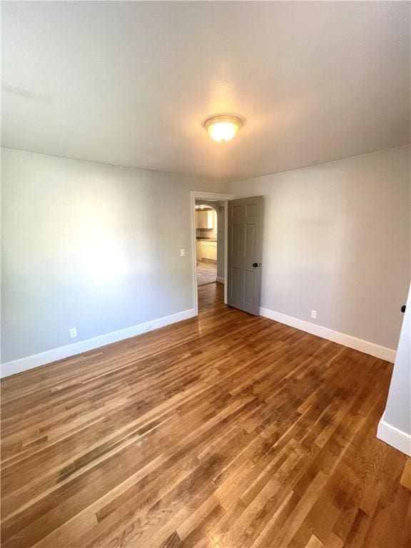 unfurnished room featuring hardwood / wood-style flooring