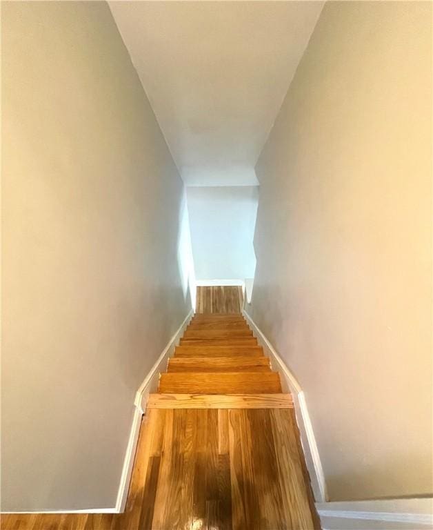 stairs featuring hardwood / wood-style floors