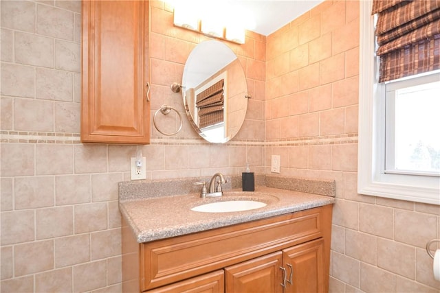 bathroom featuring vanity and tile walls