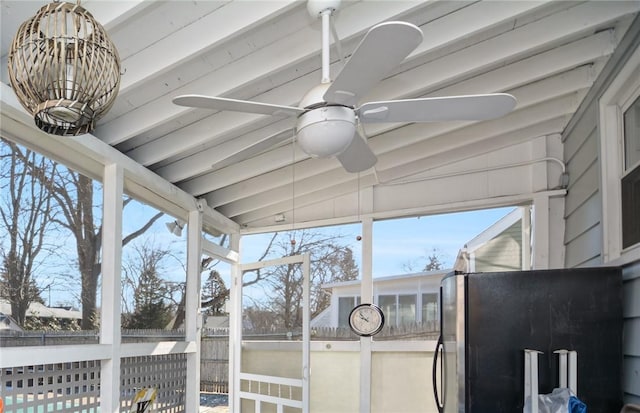 sunroom featuring lofted ceiling with beams and ceiling fan