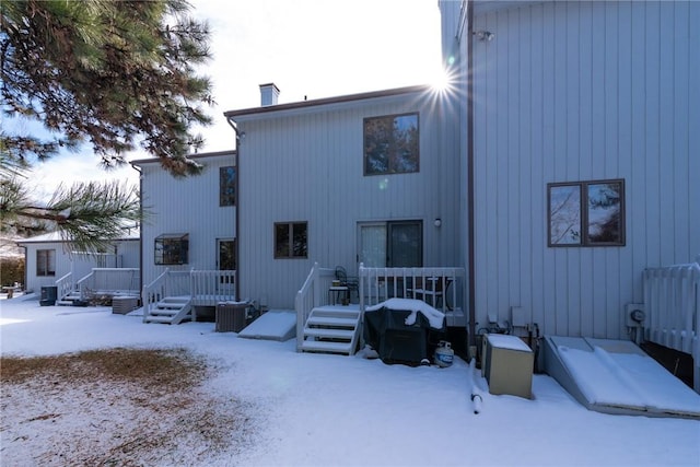 view of snow covered back of property