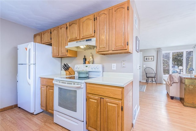 kitchen featuring white appliances and light hardwood / wood-style flooring