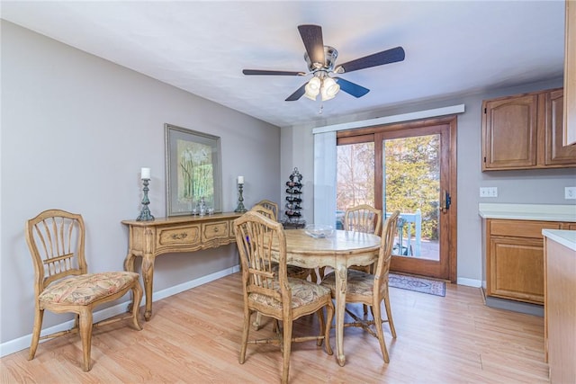 dining space with ceiling fan and light hardwood / wood-style floors